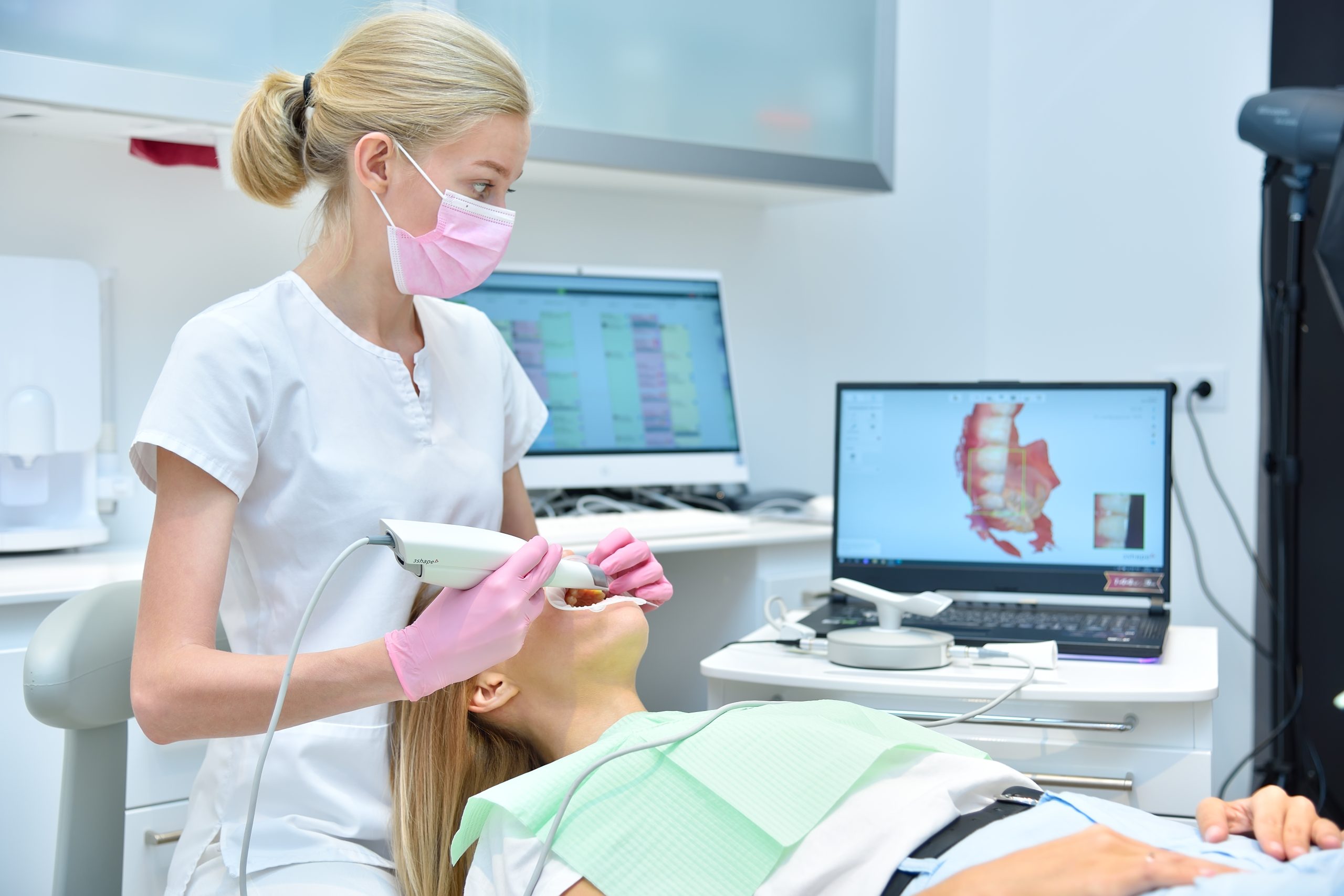 orthodontist,scaning,patient,with,dental,intraoral,scanner,and,controls,process
